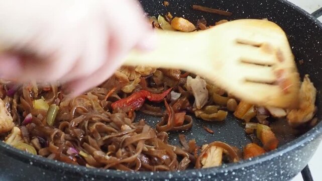 Schezwan Noodles or Vegetable Hakka Noodles or Chow Mein in white bowl. Schezwan Noodles is indo-chinese cuisine hot dish with udon noodles, vegetables and chilli sauce with meat, Japanese food