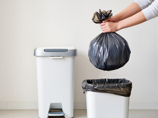 Person taking out the trash disposing of a full garbage bag