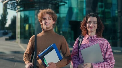 Confident university students portrait in front of modern glass campus - Powered by Adobe