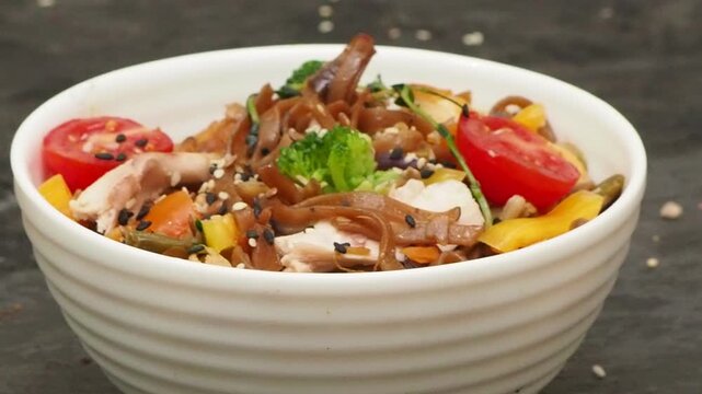 Schezwan Noodles or Vegetable Hakka Noodles or Chow Mein in white bowl. Schezwan Noodles is indo chinese cuisine hot dish with udon noodles, vegetables and chilli sauce with meat, Japanese food