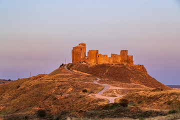Obraz premium Castillo de Montearagon standing on a hill at sunset in Quicena, Spain