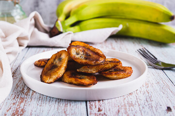 Fried plantain banana slices on a plate on the table