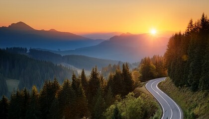 a winding road cuts through a tranquil forest leading towards a majestic mountain range with a glowing sunrise above