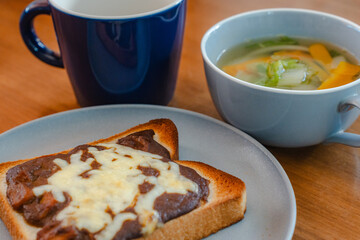 Breakfast with cheese toast, vegetable soup, and coffee

