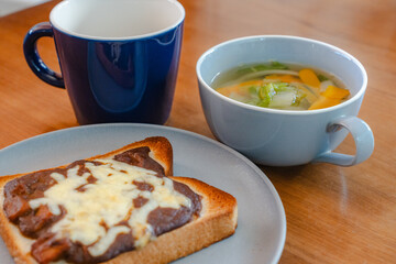 Breakfast with cheese toast, vegetable soup, and coffee
