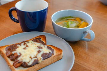 Breakfast with cheese toast, vegetable soup, and coffee
