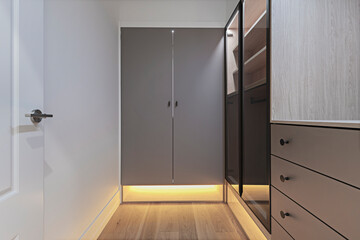 Harmonious composition of smooth cabinets with transparent glass sliding doors and clean-lined drawers