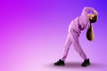 Naklejka premium Happy young girl dancing on color background