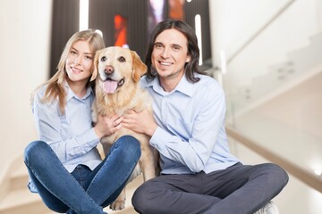 Portrait of attractive family with dog at home