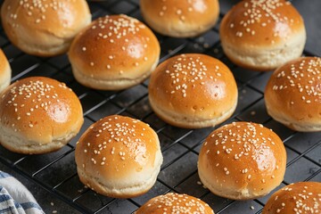 Homemade hamburger buns with sesame seeds on cooling rack