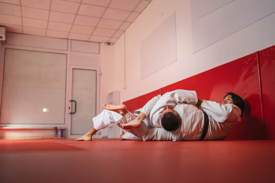 Two judo athletes training together in a modern dojo - Powered by Adobe