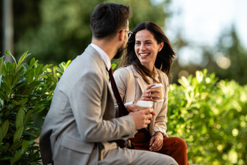Business people talking and drinking coffee outdoors