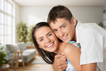 Fototapeta premium Beautiful young happy couple hugging in new apartment.
