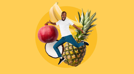 African American guy jumping over an assortment of fruits, including bananas, pineapple,...