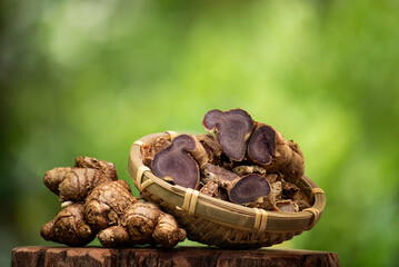 Fresh and dried slices with black galingale or kaempferia parviflora rhizomes on natural background.