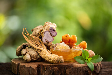 Black ginger, Korean ginseng, turmeric and honey are used to make a healthy tea on natural background.