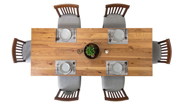 Overhead view of a wooden dining table set for six with elegant chairs and tableware - Powered by Adobe