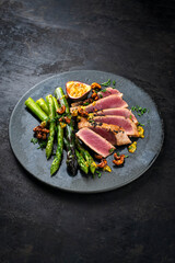 Tuna tataki steak with caramelized green asparagus, roasted cashew and  maracuja passion fruit...