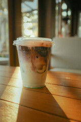 Ice Chocolate Mint on wooden table with sunlight in sunset time at cafe.