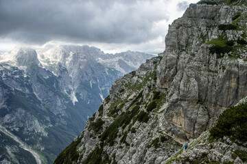 Obraz premium Hikers ascending Mount Triglav via the Cez Prag via ferrata, Julian Alps, Slovenia, adventure photography.