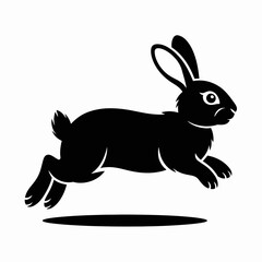 Obraz premium Silhouette of a black rabbit leaping forward with ears perked up