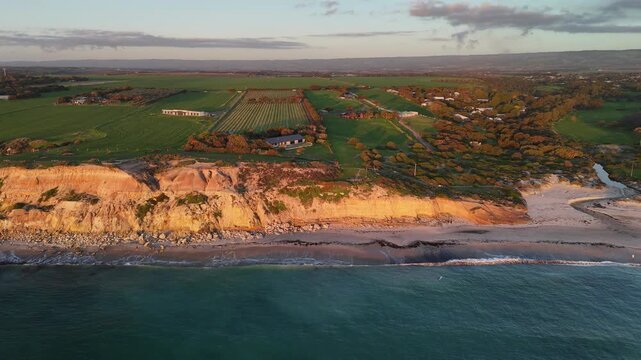 Port Willunga Beach, South Australia: 4K Aerial Drone Footage of Golden Cliffs, Golden Sand beach, Farmland Hills, Coastal Houses, Ocean Waves and Sunset Views