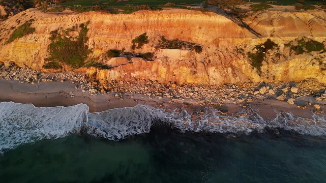 Port Willunga Beach, South Australia: 4K Aerial Drone Footage of Golden Cliffs, Golden Sand beach, Farmland Hills, Coastal Houses, Ocean Waves and Sunset Views