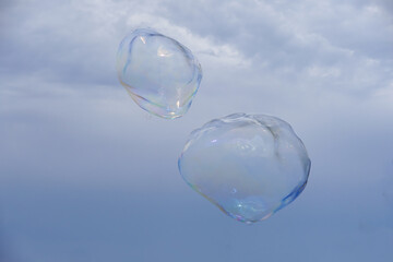 Huge bubble with blue sky and white cloud background