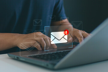 Businessman using laptop to check new email notification. Concept of digital communication, online messaging, marketing, customer support, customer service and modern workplace technology efficiency.