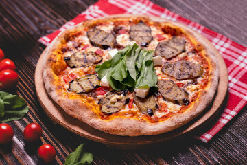 Vegetable pizza with eggplant topping. Italian style pizza with fresh vegetables. Homemade eggplant and veggie pizza. Delicious pizza with eggplant and vegetables.