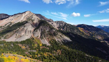 Fototapeta premium Scenic Mountain Range Landscape with Autumn Colors Under a Bright Blue Sky