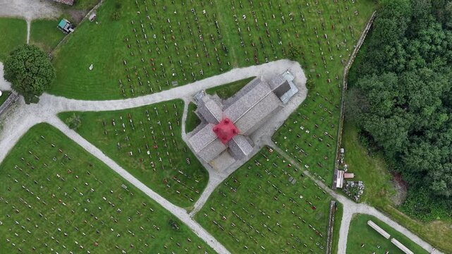 Aerial view of Ringebu Stave Church surrounded by green fields and hills in Ringebu, Norway