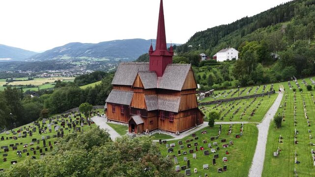 Ringebu Stave Church stands quietly in the vast green landscape, a guardian of centuries past