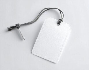 Blank white tag with gray cord, showcasing simple elegance and minimalist design.