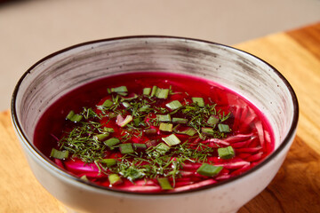 Enjoy a delightful and vibrant beetroot soup garnished with fresh, aromatic herbs