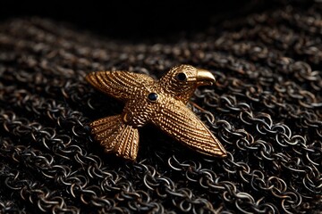 Gold eagle brooch worn a high ranking Teutonic knight detailed with black enamel lying on chainmail Symbol of martial honor and lineage