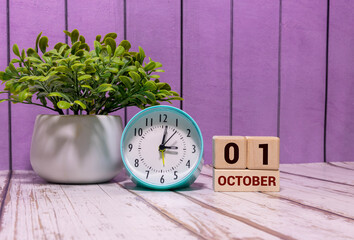 October 1st. Image of october 1 wooden color calendar on blue background.