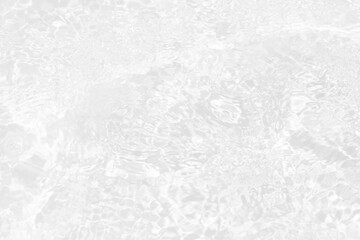 White water with ripples on the surface. Defocus blurred transparent white colored clear calm water surface texture with splashes and bubbles. Water waves with shining pattern texture background.