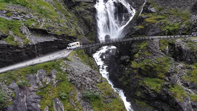 Trollstigen road and Stigfossen waterfall captured from above on a misty Norwegian day
