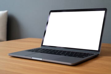 Fototapeta premium Laptop mockup on wooden desk with blank white screen for website design and application presentation