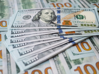 Close-Up of Stacked Hundred Dollar Bills on Table