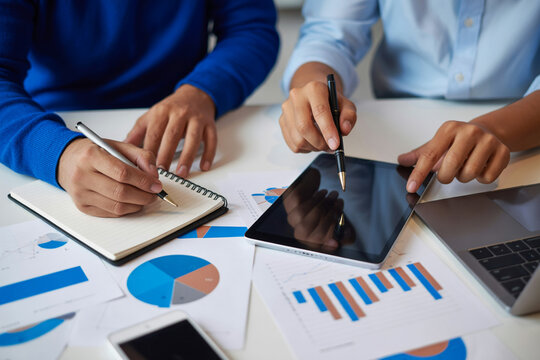 Business meeting collaboration analysis teamwork strategy planning with charts and tablet on desk concept