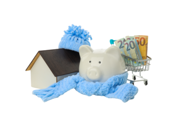 A piggy bank wrapped in a scarf near a model house, isolated, PNG