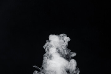 Closeup view of swirling smoke, creating an ethereal and abstract formation against a dark background. Delicate movement and form of the smoke