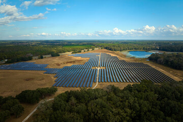 Aerial view of big sustainable electric power plant with many rows of solar photovoltaic panels for producing clean electrical energy. Renewable electricity with zero emission concept