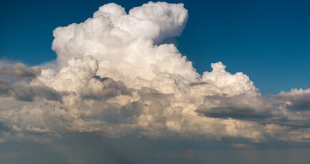Blue sky with white summer rain clouds. Colorful summer landscape