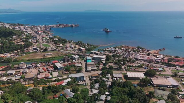 Moving aerial view of the main highway and harbour in Honiara.