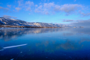 Baikal Lake in winter. Beautiful landscape with mountains reflected in ice of frozen Small Sea