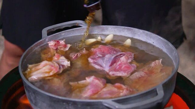Meat and garlic boiling in a pot