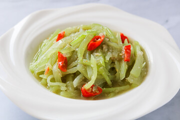 A healthy and flavorful stir-fry of sliced chayote and red chili slices, with a savory sauce.